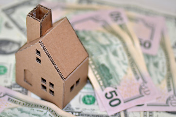 Image showing Miniature paper made house stand on  money