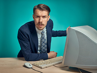 Image showing Sad Young Man Working On computer At Desk