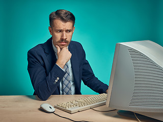 Image showing Sad Young Man Working On computer At Desk