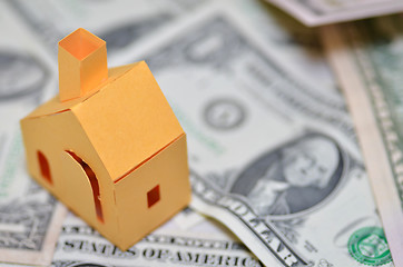 Image showing Miniature paper made house stand on  money