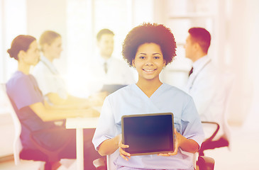 Image showing happy doctor over group of medics at hospital