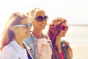 Image showing group of smiling women in sunglasses on beach