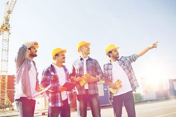 Image showing group of smiling builders with tablet pc outdoors