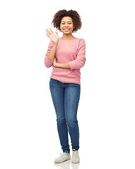 Image showing happy african american young woman waving hand