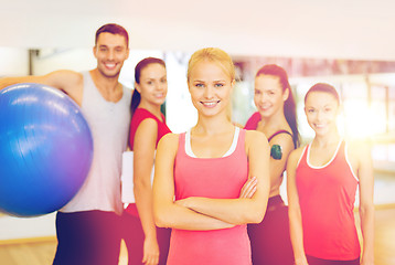 Image showing woman standing in front of the group in gym