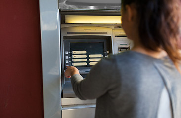 Image showing close up of woman choosing option on atm machine