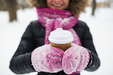 Image showing close up of hand with coffee outdoors in winter