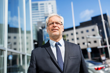 Image showing senior businessman on city street