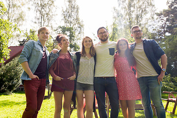 Image showing happy teenage friends hugging at summer garden