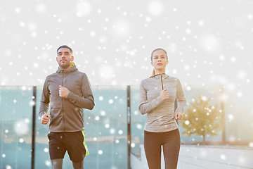 Image showing happy couple of sportsmen running in city