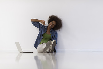 Image showing african american woman sitting on floor with laptop