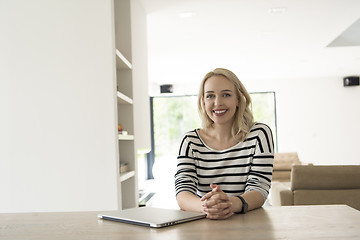 Image showing Young woman with laptop at home