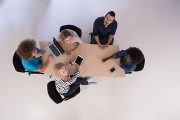 Image showing Multiethnic startup business team on meeting  top view