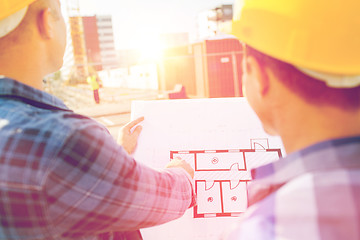 Image showing close up of builders with blueprint at building