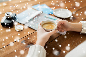 Image showing close up of hands with coffee cup and travel stuff