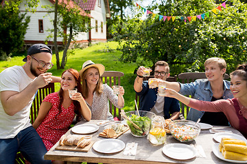 Image showing happy friends having party at summer garden