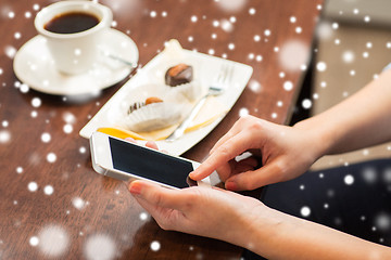 Image showing close up of woman with smartphone and dessert