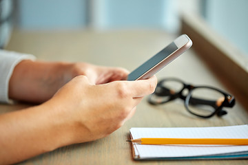 Image showing close up of woman texting on smartphone