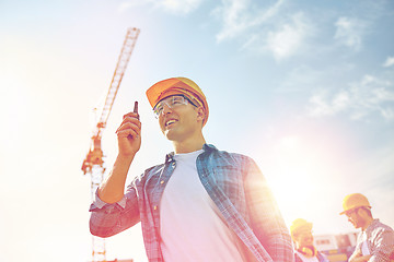 Image showing builder in hardhat with walkie talkie