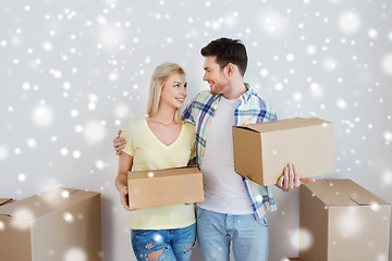 Image showing smiling couple with boxes moving to new home