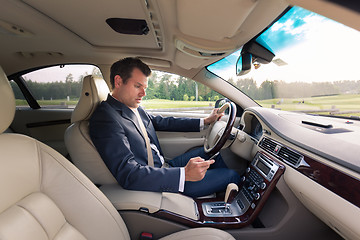 Image showing Man using cell phone while driving