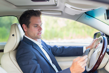 Image showing Man using cell phone while driving