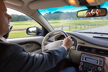 Image showing Man using cell phone while driving