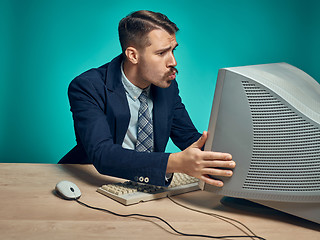 Image showing Portrait of cheerful young businessman sitting with computer