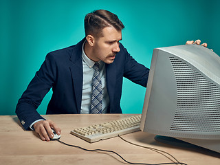 Image showing Surprised Young Man Working On computer At Desk