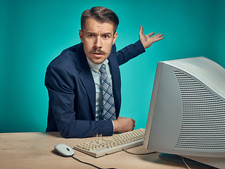 Image showing Sad Young Man Working On computer At Desk