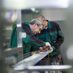 Image showing Industrial worker grinding in manufacturing plant.