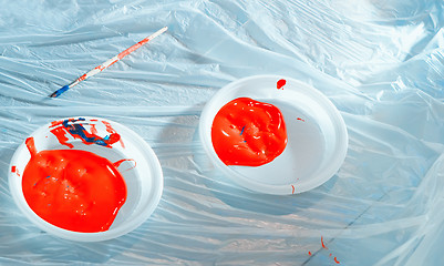 Image showing Red Paint In Plastic Plates