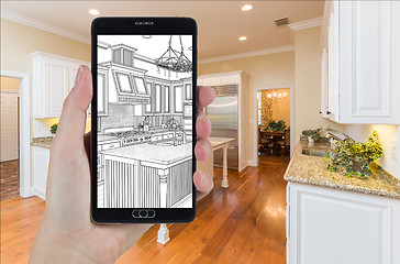 Image showing Hand Holding Smart Phone Displaying Drawing of Kitchen Photo Beh