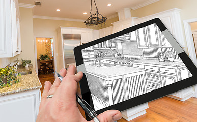 Image showing Hand on Computer Tablet Showing Drawing of Kitchen Photo Behind.