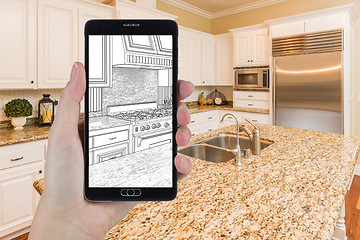 Image showing Hand Holding Smart Phone Displaying Drawing of Kitchen Photo Beh