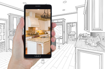 Image showing Hand Holding Smart Phone Displaying Photo of Kitchen Drawing Beh