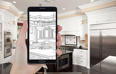 Image showing Hand Holding Smart Phone Displaying Drawing of Kitchen Photo Beh