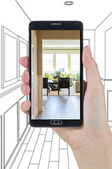 Image showing Hand Holding Smart Phone Displaying Photo of House Hallway Drawi