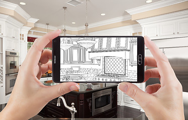 Image showing Hands Holding Smart Phone Displaying Drawing of Kitchen Photo Be