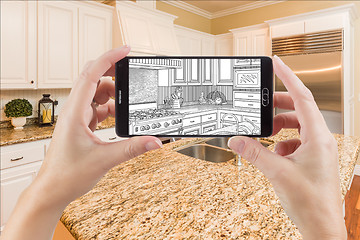 Image showing Hands Holding Smart Phone Displaying Drawing of Kitchen Photo Be