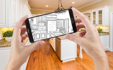 Image showing Hands Holding Smart Phone Displaying Drawing of Kitchen Photo Be