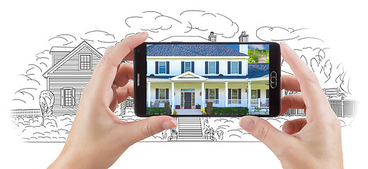Image showing Hands Holding Smart Phone Displaying Home Photo of Drawing Behin