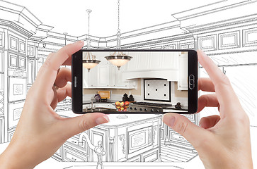 Image showing Hands Holding Smart Phone Displaying Photo of Kitchen Drawing Be