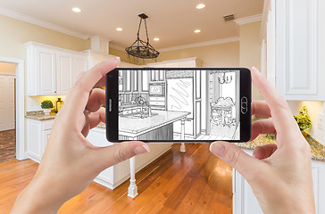 Image showing Hands Holding Smart Phone Displaying Drawing of Kitchen Photo Be