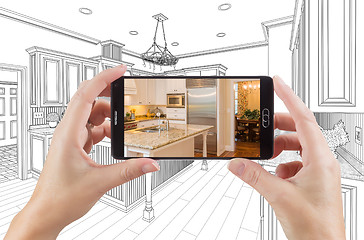 Image showing Hands Holding Smart Phone Displaying Photo of Kitchen Drawing Be