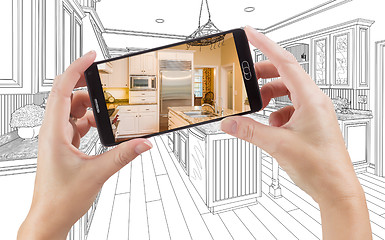 Image showing Hands Holding Smart Phone Displaying Photo of Kitchen Drawing Be