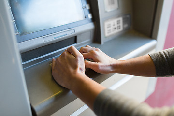 Image showing close up of hand entering pin code at atm machine