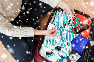 Image showing close up of woman packing travel bag for vacation