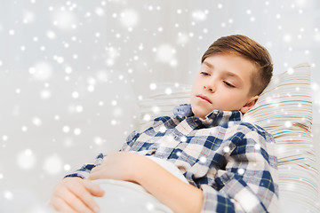 Image showing ill boy with flu lying in bed at home