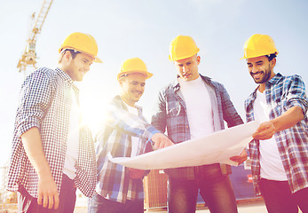 Image showing group of builders with tablet pc and blueprint